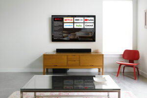 well-lit, modern hotel room with streaming apps displayed on TV