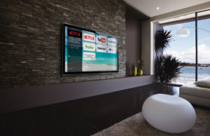 Image of a hotel room by the beach with Enseo's user interface on the TV