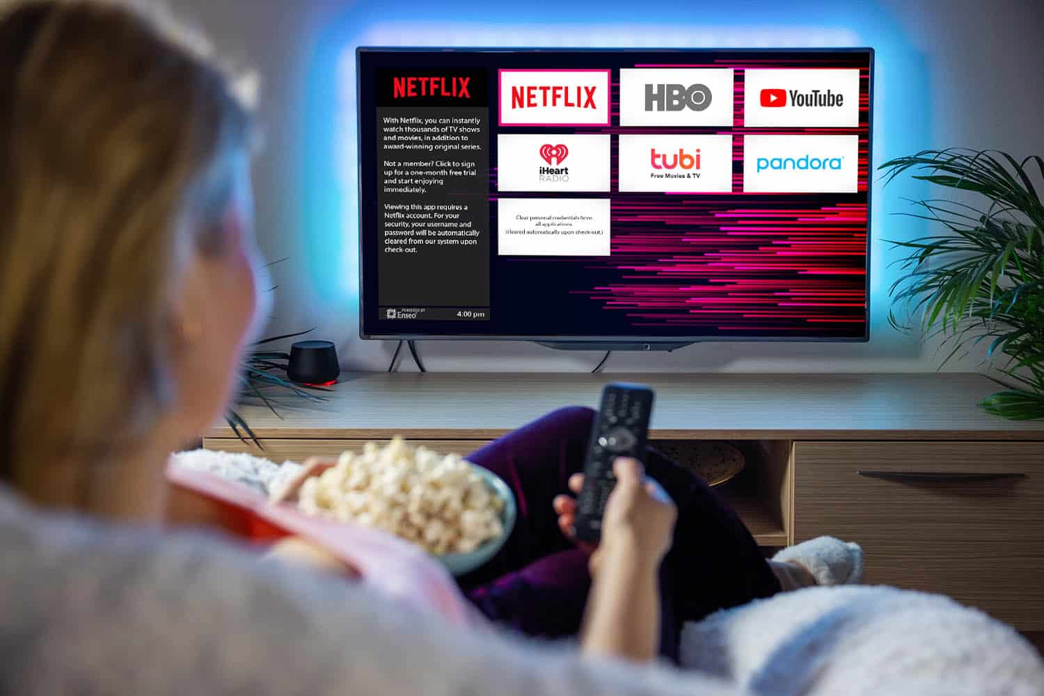 Woman relaxing at home in evening and watching TV