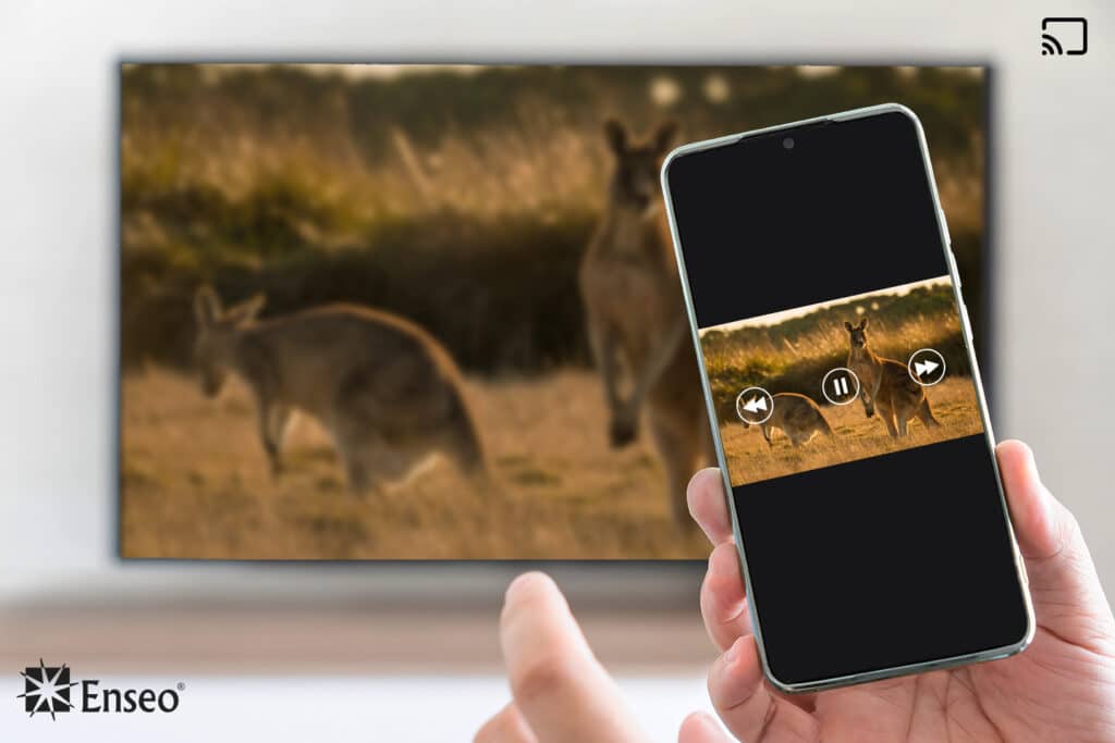 Casting by Enseo as demonstrated by a hand tapping on a smartphone with a TV screen mirroring in the background.